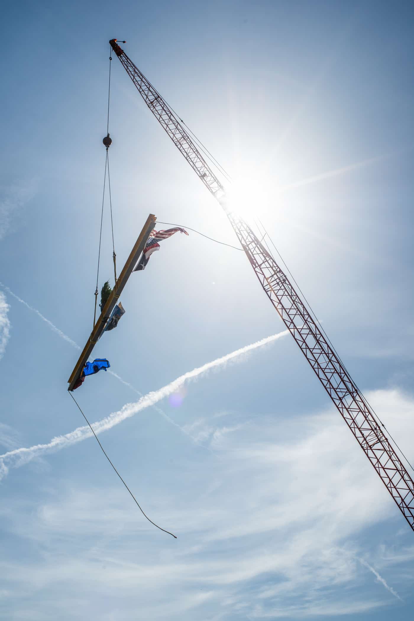 A crane holding a pole. 