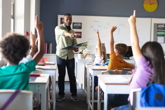 Male teacher in front of a classroom.