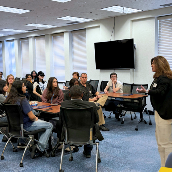 A person speaking to a classroom of people