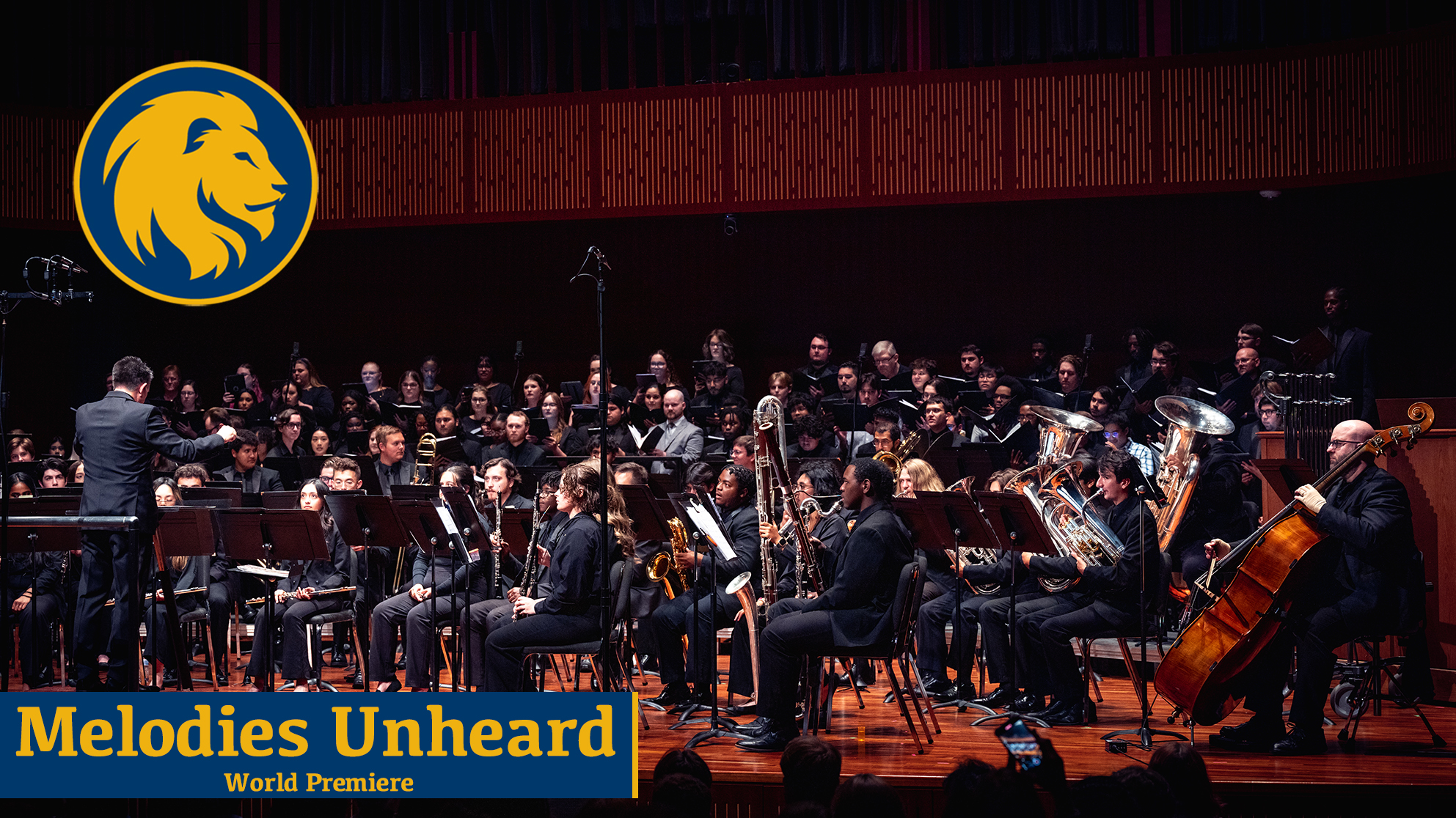 A music ensemble being led by a conductor during a concert.