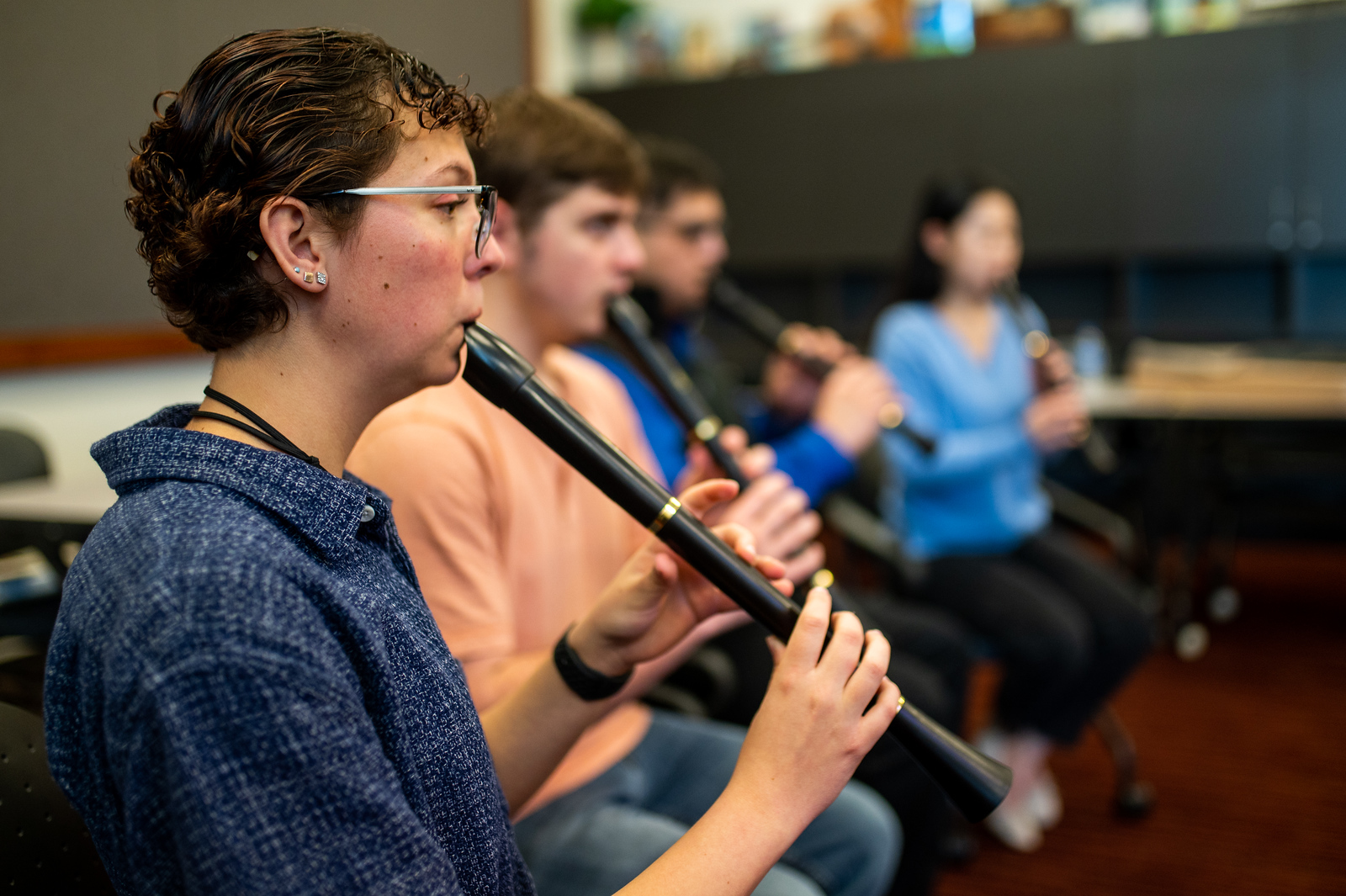 A group of students playing the flute.