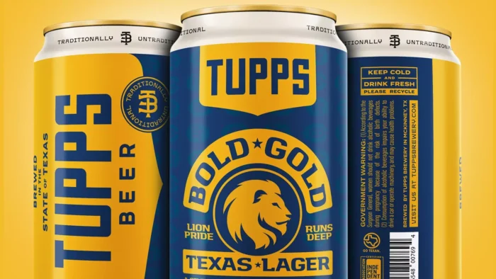 Close-up of blue and gold beer can with "Tupps" printed at the top and Lion logo below.