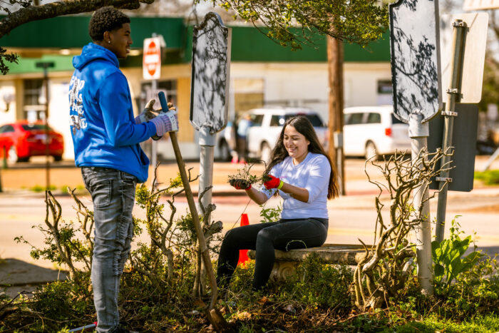 Two students volunteering for community cleanup