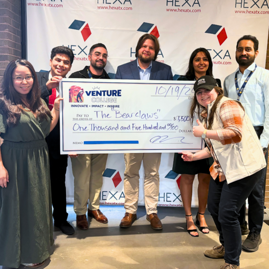 A group of people pose for a photo with an oversized cheque for $1,500