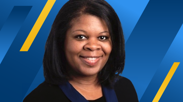 ETAMU alum Sharlene Belton-Gonzalez on a blue- and gold-barred background