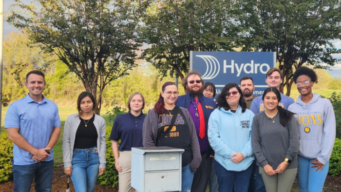 A group of people pose for a photo outdoors.