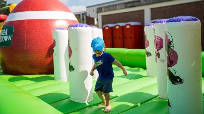 A child playing on an inflatable play space.