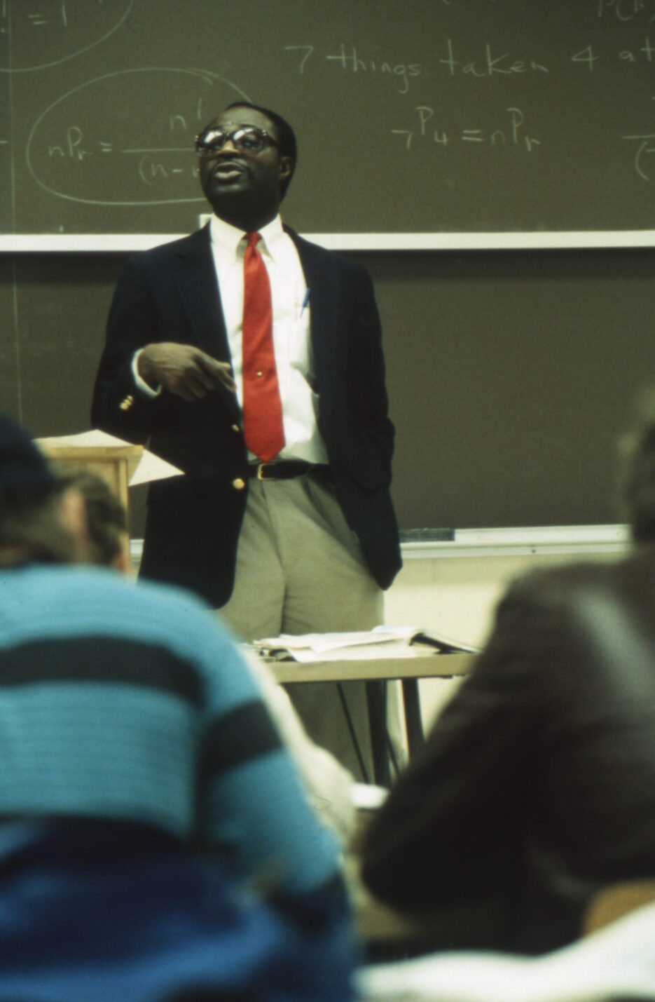 A photo from 1992 of a college professor teaching in a classroom.