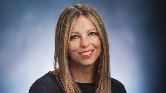 A woman smiles at the camera in a headshot photo.